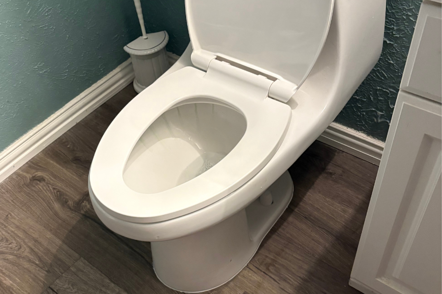 CW Service Pros installing a toilet in a residential home in DFW.