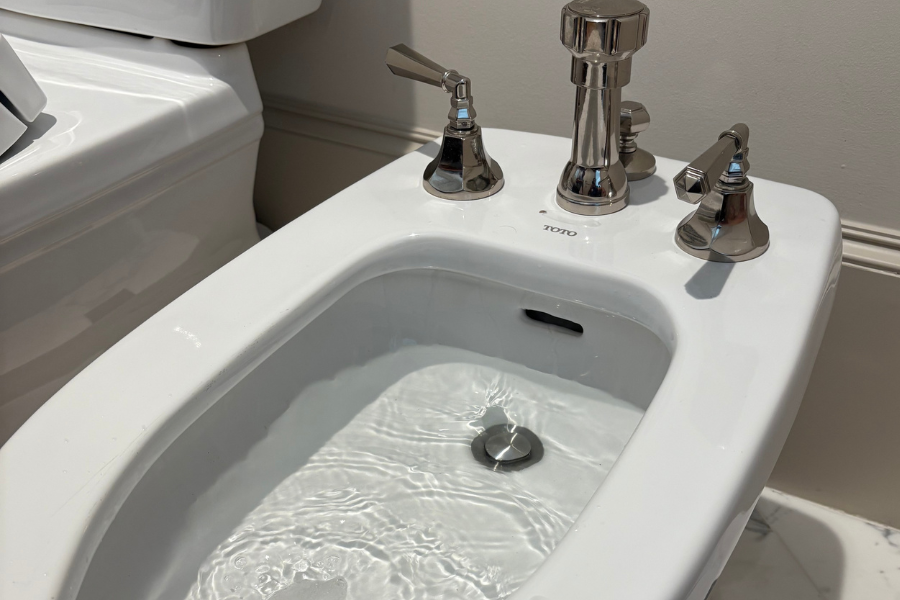 Modern standalone bidet installed in a residential bathroom for improved hygiene and comfort.