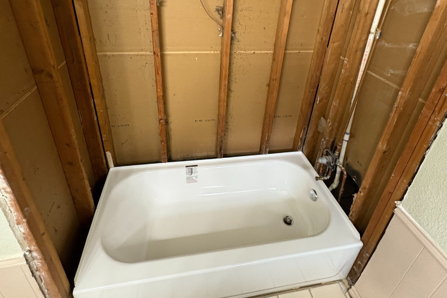 CW Service Pros installing a new bathtub during a bathroom remodel in Plano, Texas.