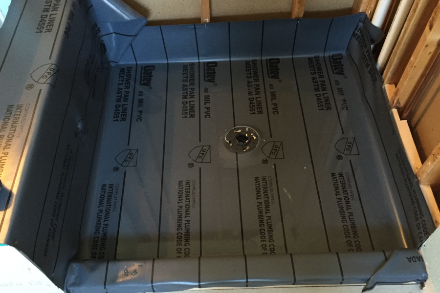 CW Service Pros installing a new shower pan as part of a bathroom remodel in a residential home.