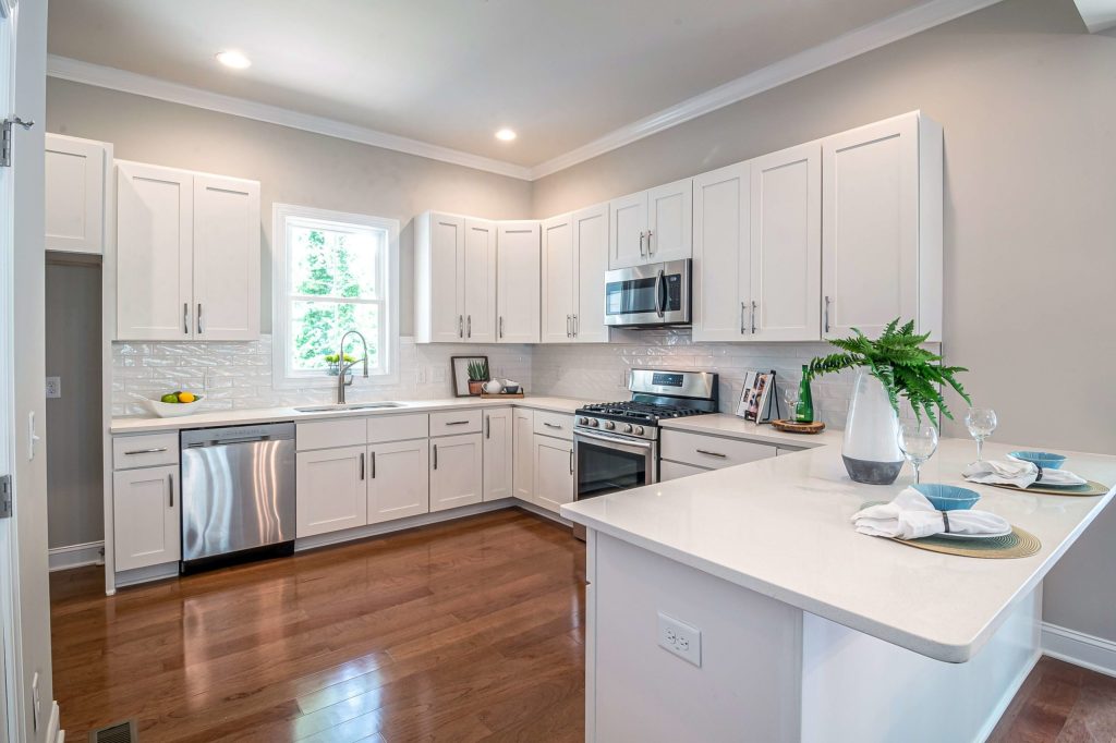 Modern white kitchen with island and stainless steel appliances