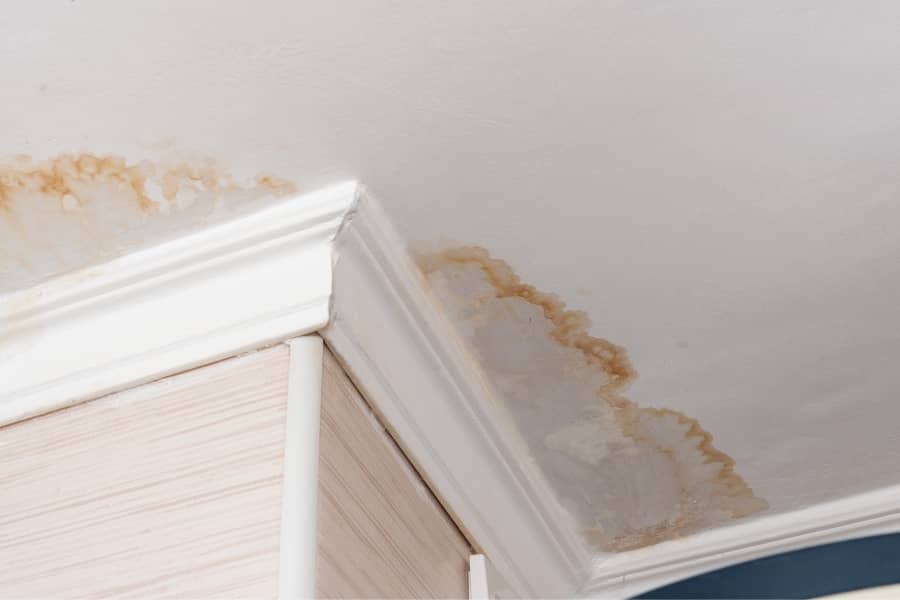 Residential water damage on ceiling near corner molding