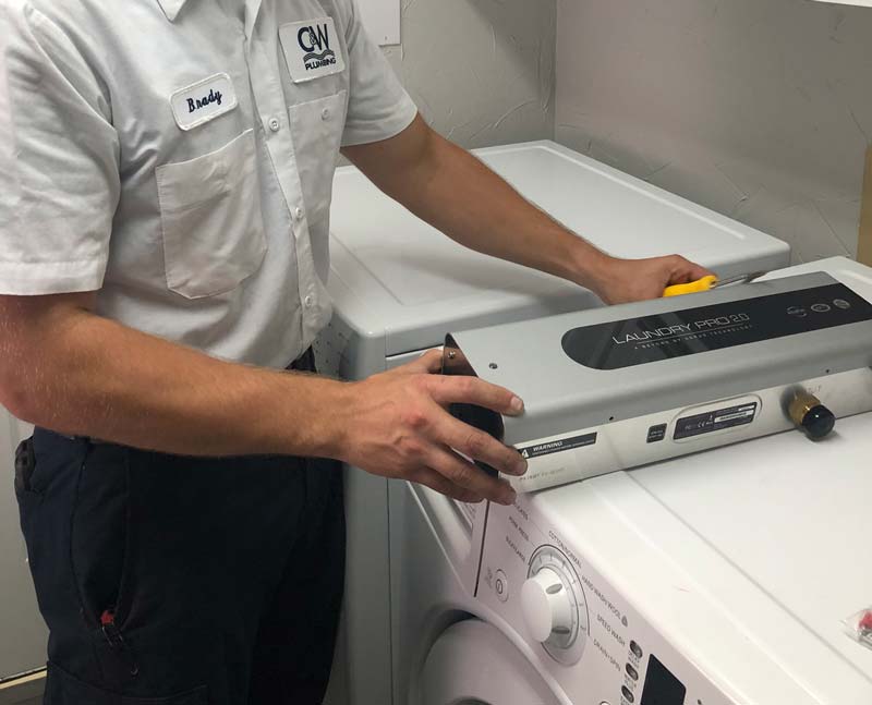 CW Service Pros technician installing Laundry Pro 2.0 system