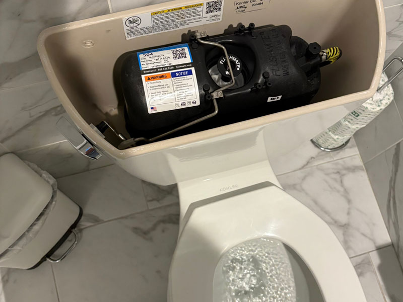 CW Service Pros toilet installation showing internal tank components in Lewisville TX