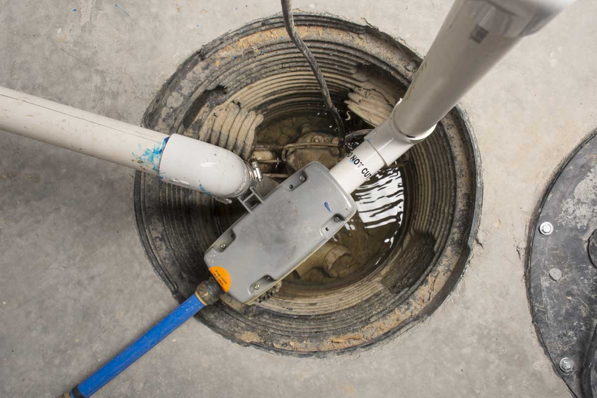 Sump pump system serviced inside basement pit in Hickory Creek TX