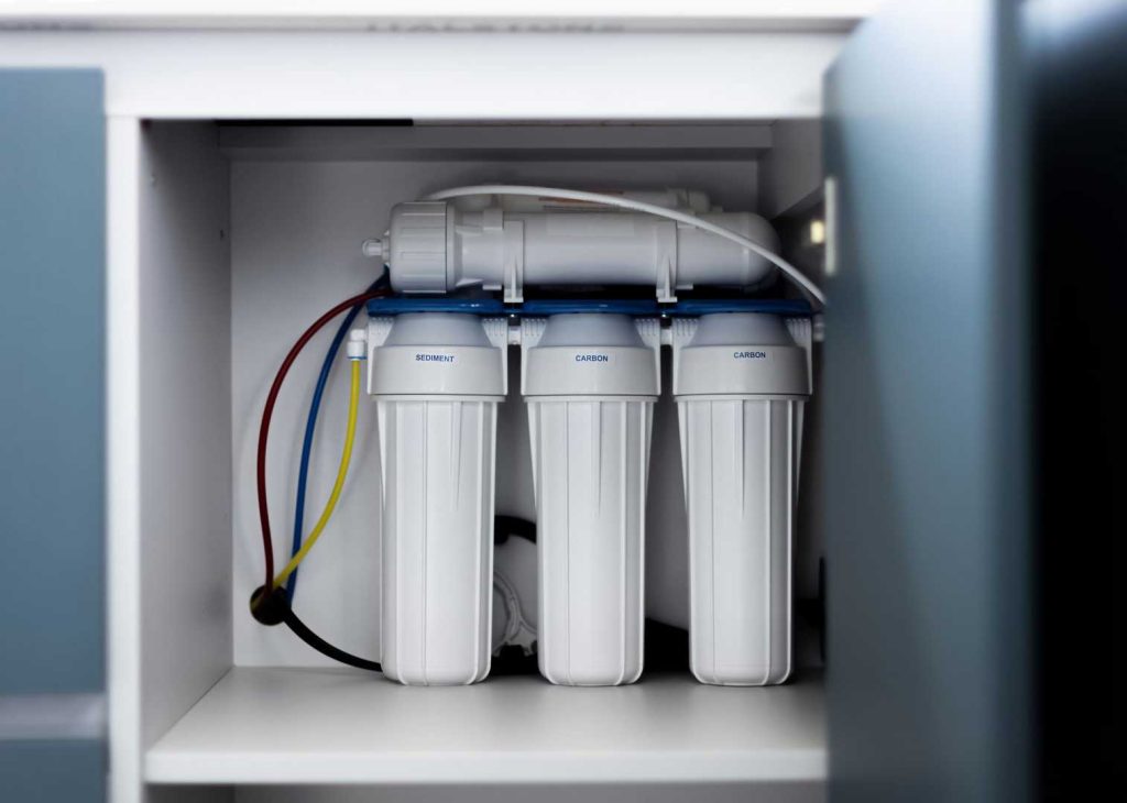 Under sink water filtration system installed inside kitchen cabinet in Little Elm TX
