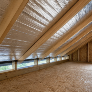 Radiant barrier foil installed under attic roof rafters in a North Texas home.