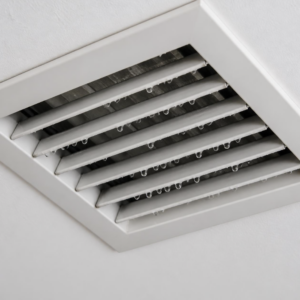 Water droplets condensing on an AC ceiling vent register in a North Texas home.